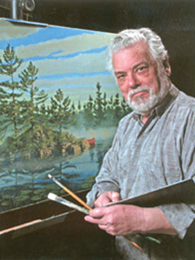 Man looking at camera with palette and paint brush in hand and a painted canvas behind him.