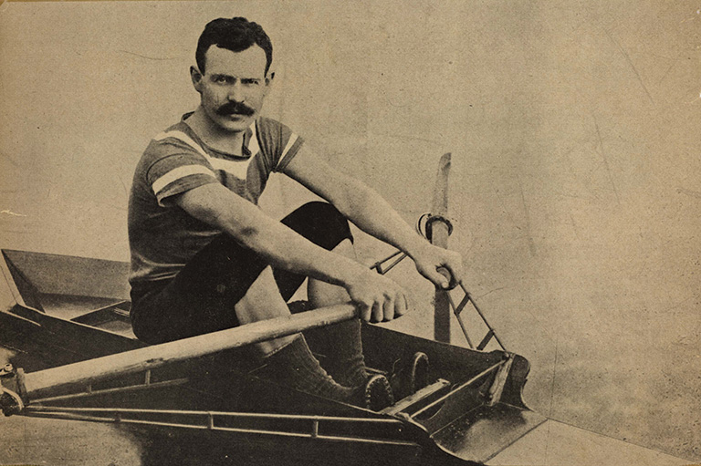 Man in short sleeves with in a tiny boat.