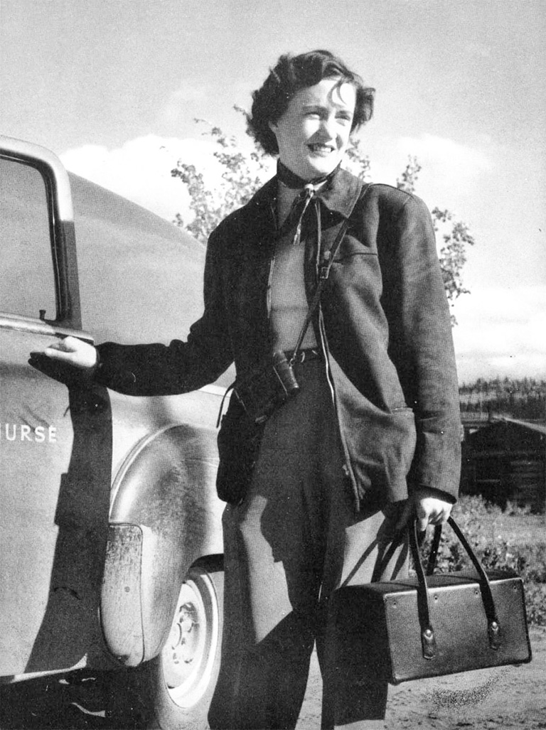 A women stands next to a truck 