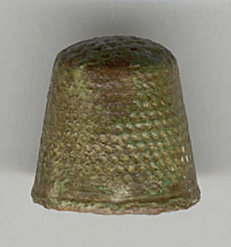 Old thimble on white background.