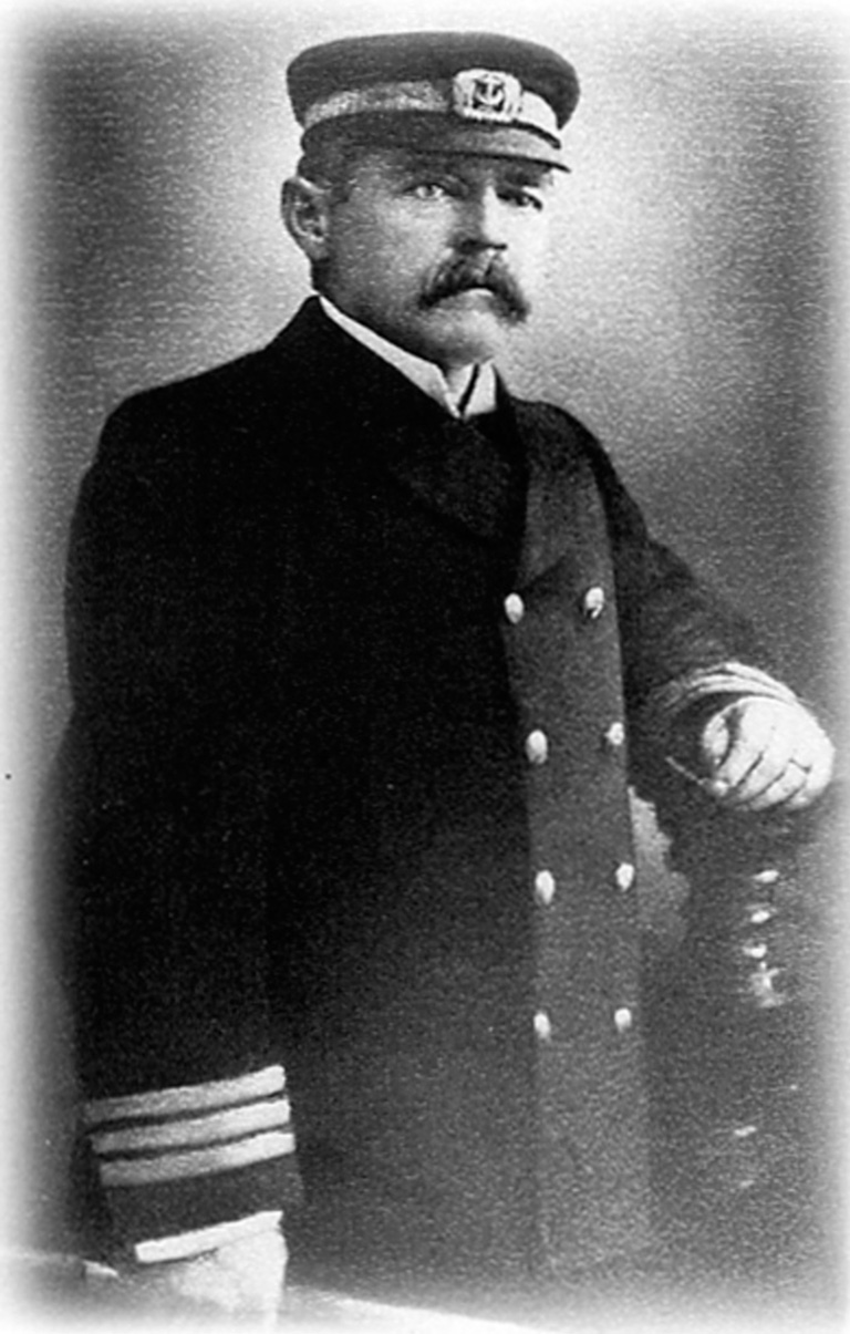 A man with a mustache in a uniform posing for a photo