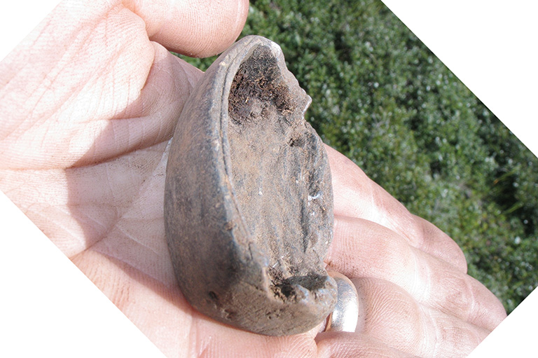 A small carved stone in the palm of a hand