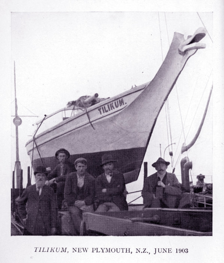 People standing in front of a boat.
