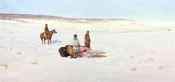 Two people standing near a buffalo that is laying on the ground, one man sits on his horse and watches. 