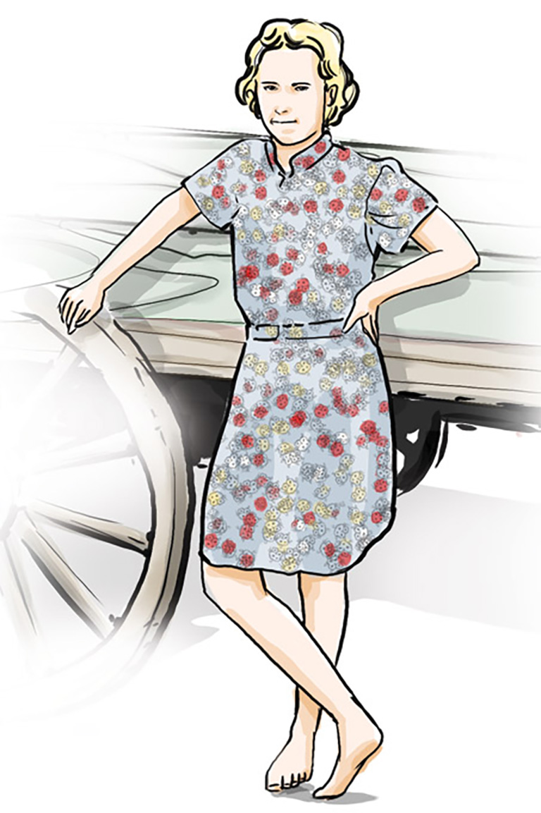 This image shows a woman in a floral dress leaning on a wagon.