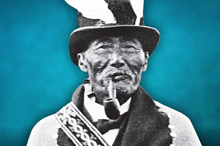 Chief Isaac with a pipe in his mouth against a teal-coloured background.