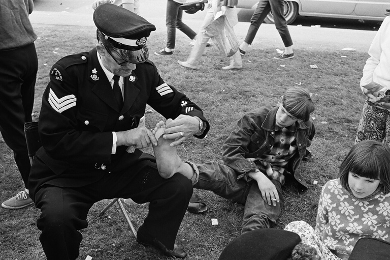 A man wraps a boy's foot. 