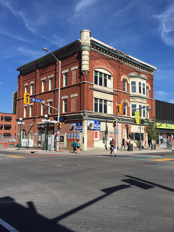 This image shows a 3 storey building with orange brick. 