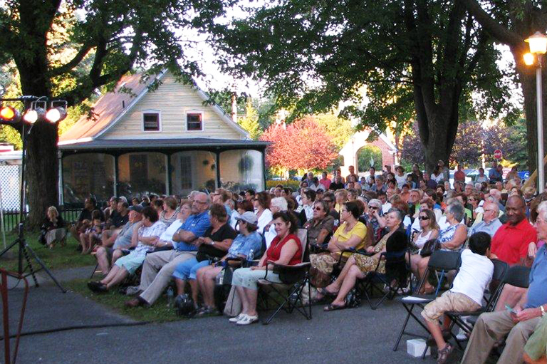 Residents of Saint-Basile-le-Grand gather to watch videos highlighting their community's history. 