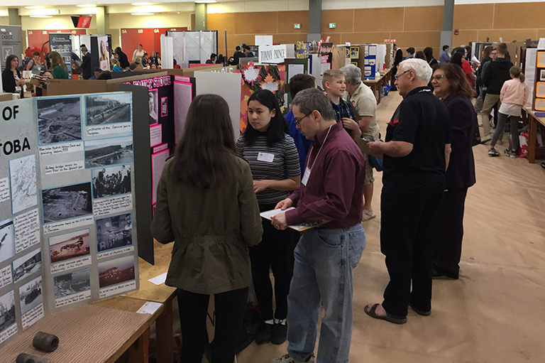 This image shows Judges speaking with students at the Red River Heritage Fair. 